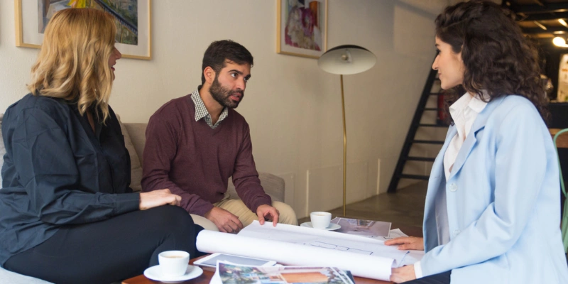 Real estate agent meeting with clients to discuss a property referral and trusted introduction