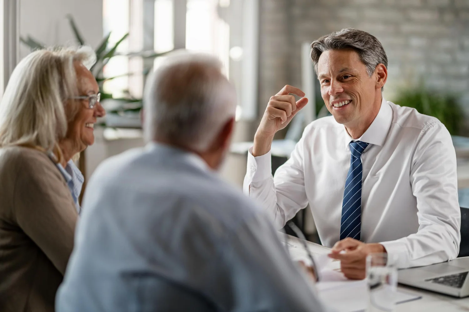 Experienced real estate professional meeting with clients to discuss trusted real estate guidance