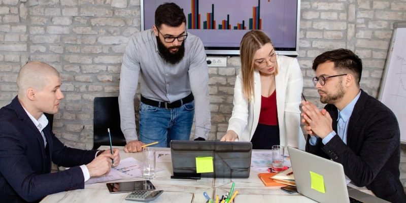 Business team reviewing documents and planning a structured real estate referral network process